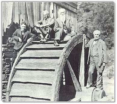 On an ancient waterwheel in West Virginia in 1918,the Four Vagabonds pose for a cameraman. Left to right are Harvey Firestone, Henry Ford, John Burroughs  and Thomas A. Edison.